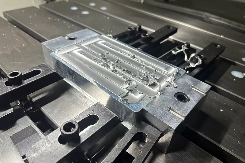 Precision CNC machined aluminum part on machine table